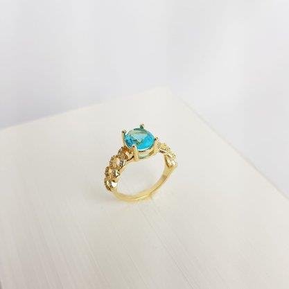 ANEL ELOS CRAVEJADO ZIRC REDONDA AZUL CLARO| BANHADO EM OURO 18K