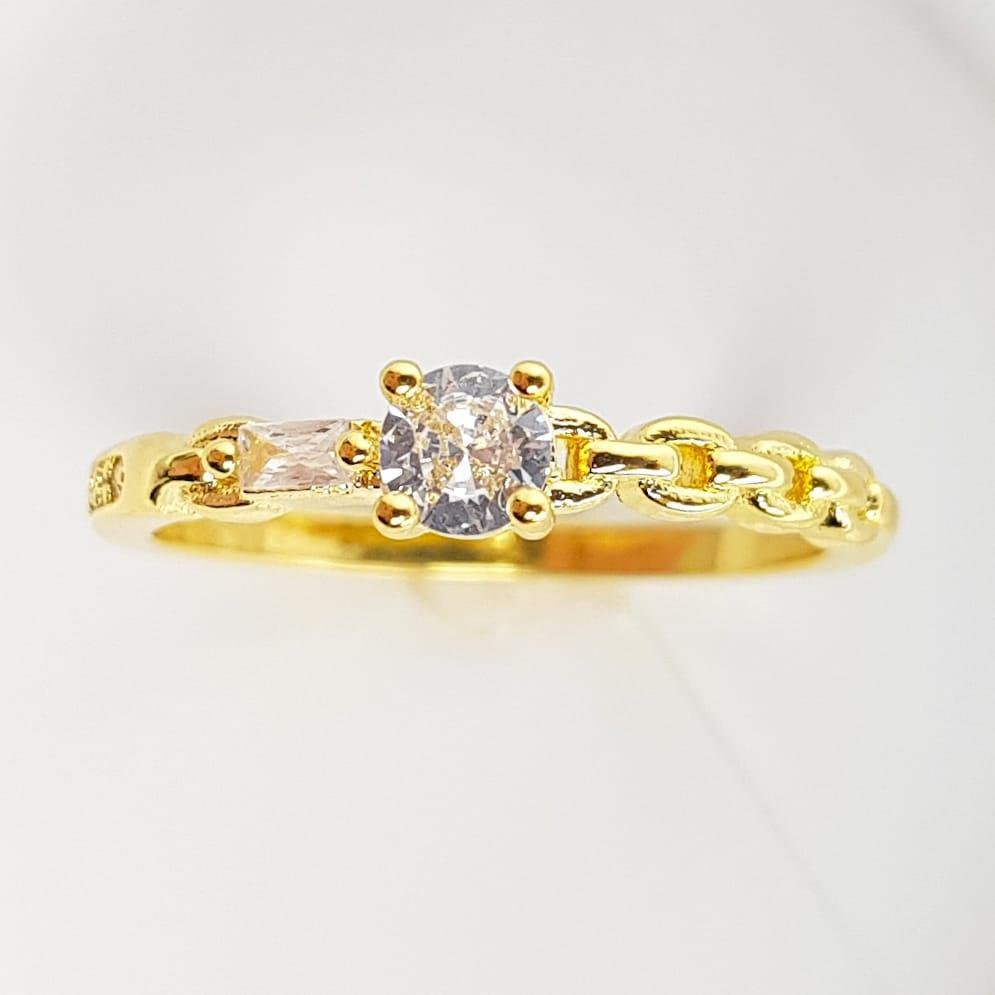 ANEL SOLITARIO EM ELOS ENTRELAÇADOS/BAGUETE/PONTO DE LUZ AO MEIO